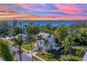 Two-story house with waterfront views, palm trees, and a sunset at 602 84Th Nw St, Bradenton, FL 34209