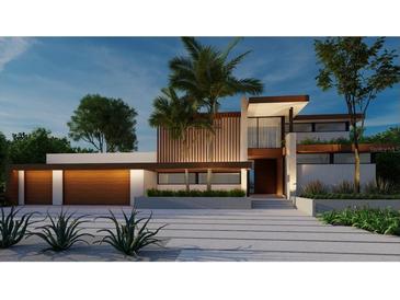 Modern home with wood and white accents, two-car garage, and palm trees at 109 N Warbler Ln, Sarasota, FL 34236