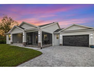 Modern single story home with screened porch and paver driveway at 2129 Lorraine Dr, Port Charlotte, FL 33953