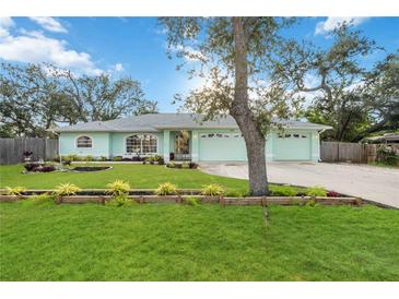 Charming home featuring a well-maintained lawn and a beautiful light green exterior at 611 Mobile Rd, Venice, FL 34293