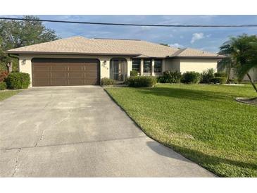 Single story home with brown garage door and well-maintained lawn at 1478 Navigator Rd, Punta Gorda, FL 33983