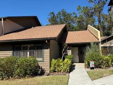 Exterior view of a charming condo with a walkway and landscaping at 919 Sunridge Dr # 919, Sarasota, FL 34234