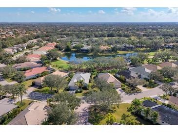 An aerial view of a beautiful community with lush landscaping and a serene lake at 12240 Thornhill Ct, Lakewood Ranch, FL 34202