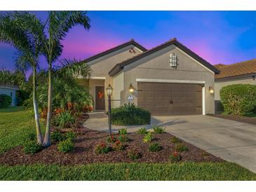 Attractive single-story home with landscaping and two-car garage at 12640 Coastal Breeze Way, Bradenton, FL 34211