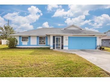 Inviting house with light blue accents and a well-maintained lawn at 1565 Piedmont Rd, Venice, FL 34293