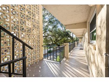 Exterior view of a two-story building with parking and landscaping at 2280 Stickney Point Rd # 420, Sarasota, FL 34231