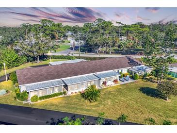 Aerial view of a charming single story home with lush lawn at 2431 Golf Course Dr # 703, Sarasota, FL 34234