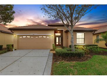 Charming single-story home featuring a two-car garage, tiled roof, and well-manicured front yard at 340 Cedar Falls Dr, Apollo Beach, FL 33572