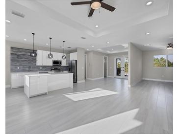 Spacious living room with open floor plan and tile flooring at 14065 Paris Ln, Port Charlotte, FL 33981