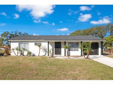 Charming single-story home with a modern exterior and landscaped yard at 7555 Hanchey St, North Port, FL 34287