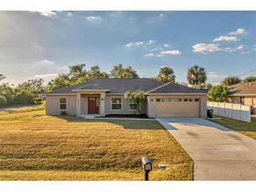 Newly constructed one-story home with attached garage and spacious lawn at 5271 Beckham St, North Port, FL 34288