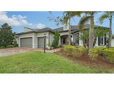 Two-story house with gray siding, two-car garage, and landscaping at 6839 Chester Trl, Bradenton, FL 34202