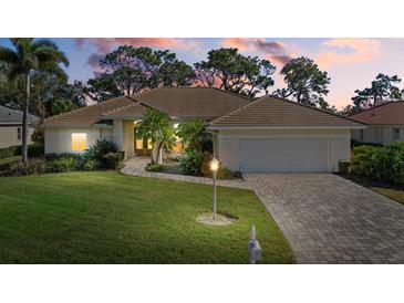 Single-story home with tile roof and landscaped lawn at 8111 Fairhaven Glen, University Park, FL 34201