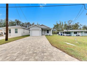 Newly built home with a paved driveway and landscaped lawn at 1006 Hagle Park Rd, Bradenton, FL 34212