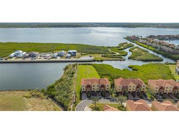 Aerial view of waterfront property, showcasing a community of townhouses with water access at 1309 3Rd Street E Cir, Palmetto, FL 34221