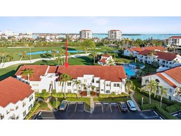 Complex overview: community pool, building, parking and golf course views at 6059 Bahia Del Mar Blvd # 239, St Petersburg, FL 33715