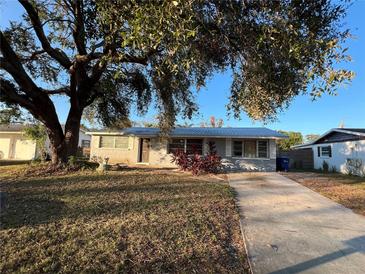 Single story home with gray exterior and driveway at 4951 Bell Meade Dr, Sarasota, FL 34232