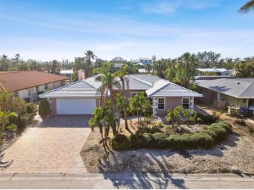 Single-Gathering home with a tile roof and landscaped yard at 322 Avenida De Paradisio, Sarasota, FL 34242