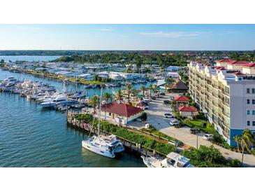 Gorgeous aerial view of the community marina with yachts, waterways, and clubhouse in this waterfront neighborhood at 505 Tamiami N Trl # 201, Venice, FL 34285