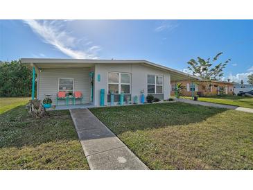 Charming ranch home with a landscaped lawn and walkway at 740 Floral Ln, Port Charlotte, FL 33952