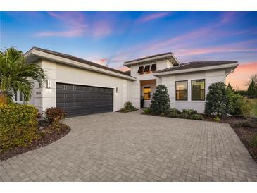 Modern two-story house with a dark gray garage door and paved driveway at 17424 Cresswind Ter, Bradenton, FL 34211