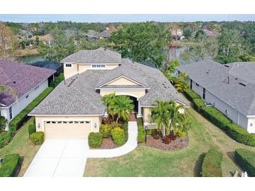 Two-story house with lake view and nicely landscaped yard at 6476 Royal Tern Cir, Lakewood Ranch, FL 34202