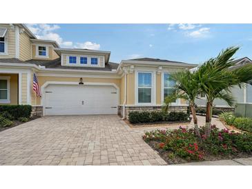 Inviting exterior of a two-story house with a paved driveway and landscaping at 3625 Tin Cup Blvd, Sarasota, FL 34232