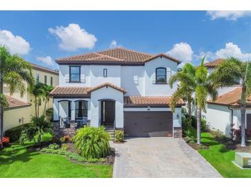 Two-story house with a brown roof, white walls, and a brick driveway at 5415 Title Row Dr, Bradenton, FL 34210