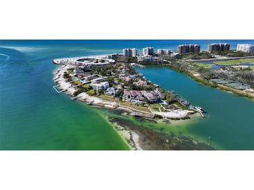 Aerial view of waterfront property with private beach and luxurious homes at 50 Lighthouse Point Dr, Longboat Key, FL 34228