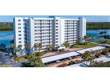 Condo building with parking, landscaping, and waterfront access at 9393 Midnight Pass Rd # 201, Sarasota, FL 34242