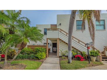 Condo building exterior with landscaped grounds and walkway at 119 Tidewater Dr # 119, Bradenton, FL 34210
