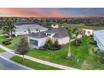 Aerial view of a house and neighborhood at sunset at 4939 Surfside Cir, Bradenton, FL 34211