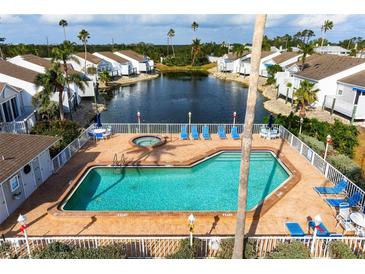 Community pool with spa and lounge chairs, offering a relaxing waterfront view at 502 Woodstork Cir, Bradenton, FL 34209