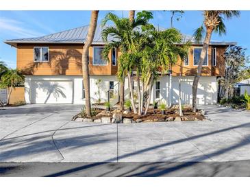 Modern two-story home with attached garage and lush landscaping at 521 Cummings St, Sarasota, FL 34242