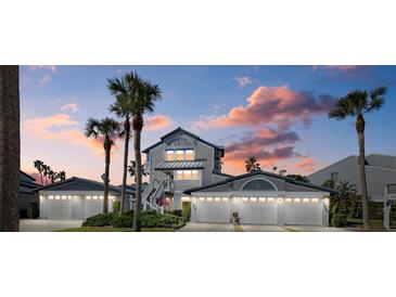 Two-story waterfront home with attached garage and palm trees at 1325 Siesta Bayside Dr # 1325B, Sarasota, FL 34242