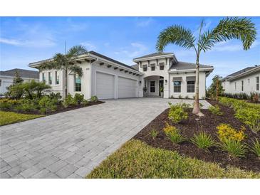 Stunning curb appeal with 3-car garage and lush landscaping at 8328 Sea Glass Ct, Sarasota, FL 34240