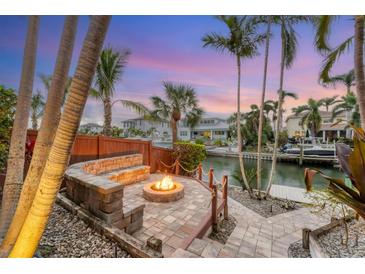 Waterfront fire pit with seating, offering tranquil views at 1739 Shelburne Ln, Sarasota, FL 34231