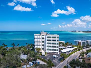 Aerial view of beachfront high-rise building with ocean views at 4822 Ocean Blvd # 8B, Sarasota, FL 34242