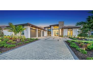 Stunning curb appeal with a modern design, landscaped grounds, and a paved driveway at 1206 Blue Shell Loop, Sarasota, FL 34240
