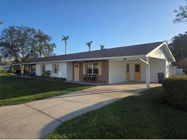 Ranch-style home with carport and mature landscaping at 4514 103Rd W St, Bradenton, FL 34210