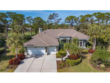 Beautiful home with tile roof, landscaping, and a 3-car garage at 1965 White Feather Ln, Nokomis, FL 34275