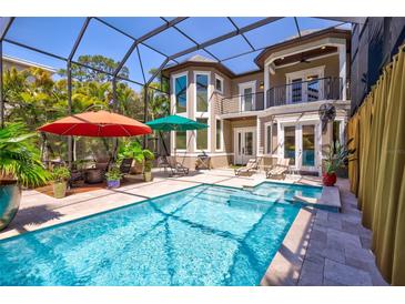 Inviting pool area with covered patio and lush landscaping at 2139 Hawthorne St, Sarasota, FL 34239
