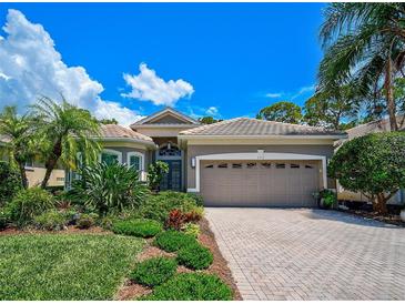 Attractive single-story home with a gray exterior, tile roof, and landscaped front yard at 293 Turquoise Ln, Osprey, FL 34229