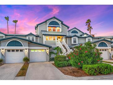 Charming two-story home with white siding, blue accents, and a landscaped front yard at 1341 Siesta Bayside Dr # 1341-B, Sarasota, FL 34242