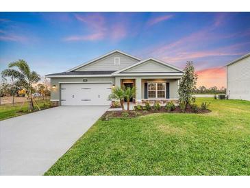 New single-Gathering home with a two-car garage and landscaped lawn at 17211 7Th E Ave, Bradenton, FL 34212