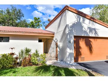 Inviting exterior with a charming gate and lush landscaping at 3404 Falcon Pl, Bradenton, FL 34210