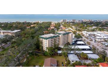 Aerial view of a condo building near the beach, with ample parking and lush landscaping at 512 W Venice Ave # 401, Venice, FL 34285