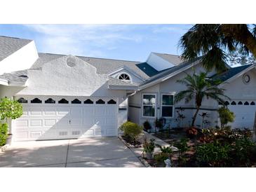 Well-maintained house with a white garage door and landscaped front yard at 11013 Jasmine Cir, Bradenton, FL 34209