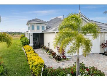 Attractive home exterior with landscaped walkway and two-car garage at 226 Van Gogh Cv, Bradenton, FL 34212