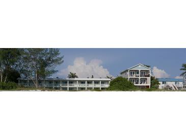 Beachfront property showcasing two buildings with balconies and beach access at 2310 Gulf N Dr # 205, Bradenton Beach, FL 34217